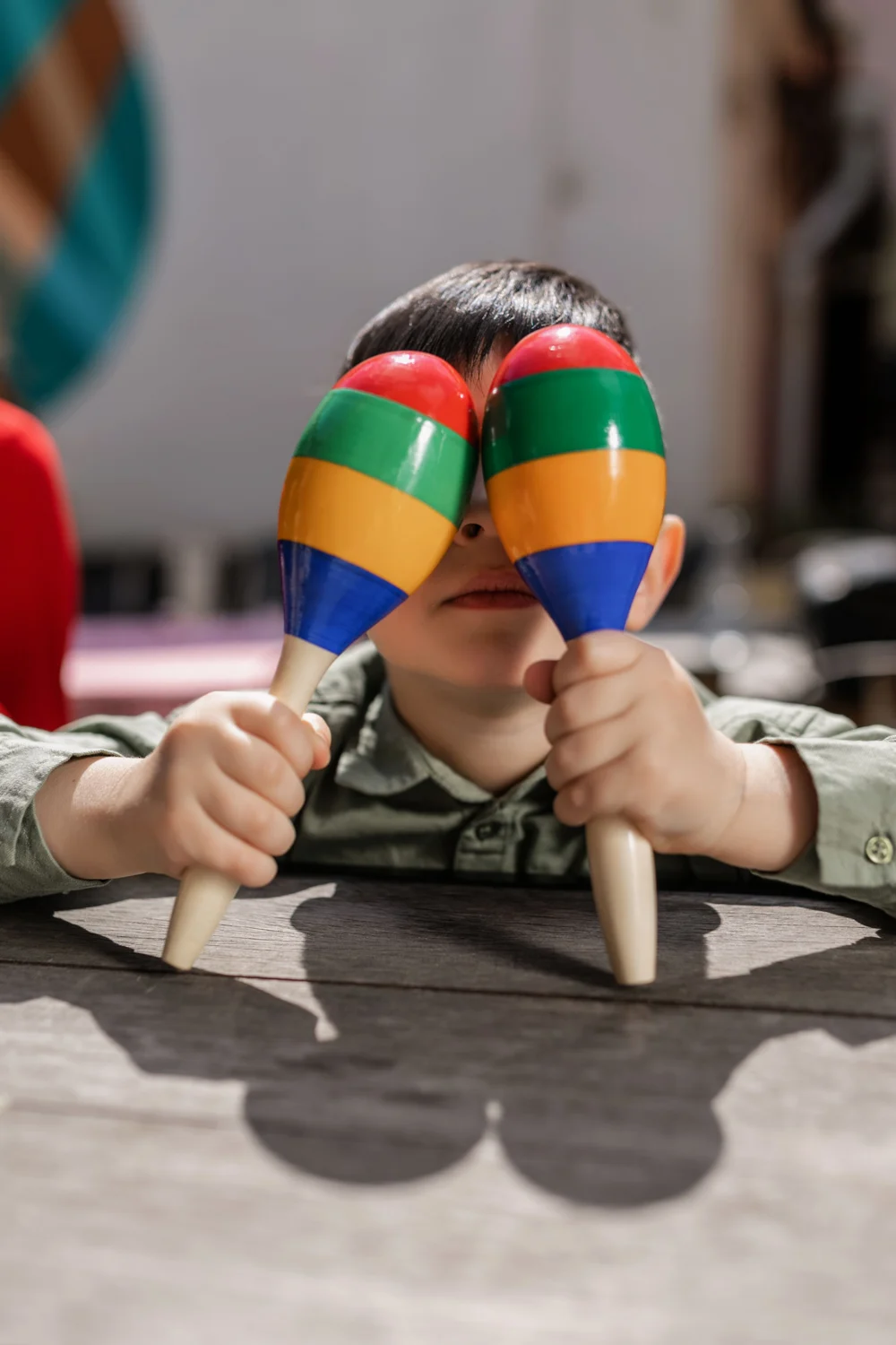 A child discovering colourful maracas